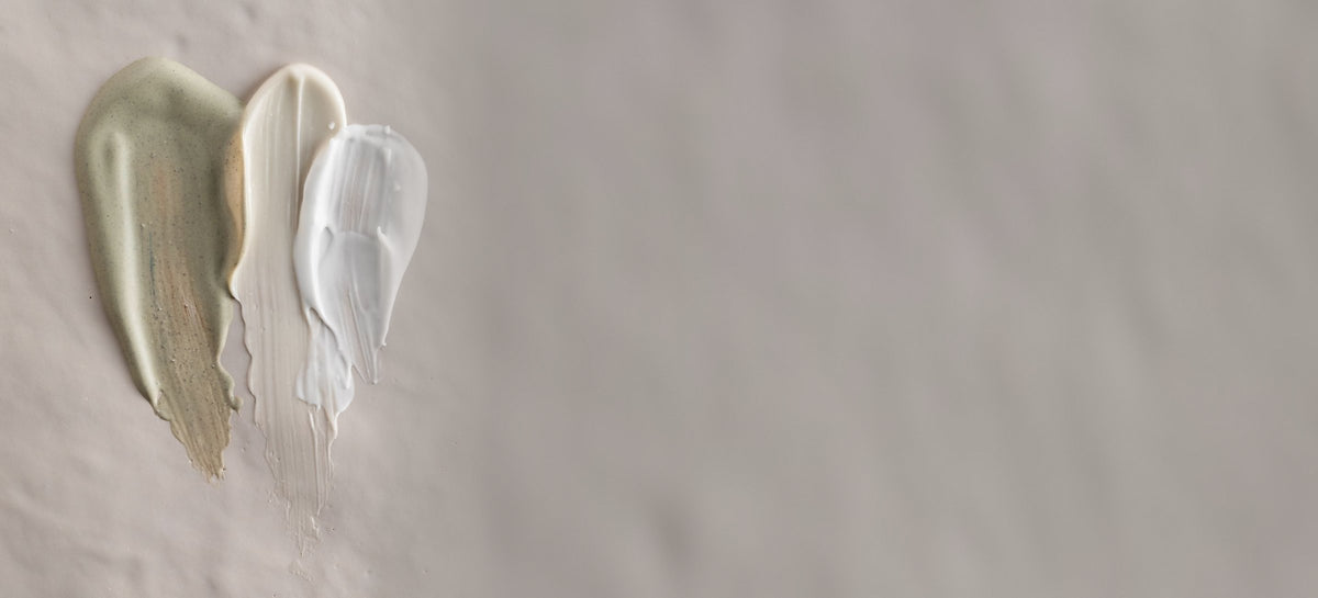 Three skincare swatches on a soft grey background