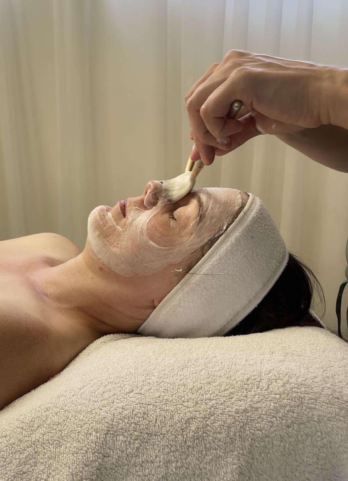 Applying a treatment mask at Facial Theory